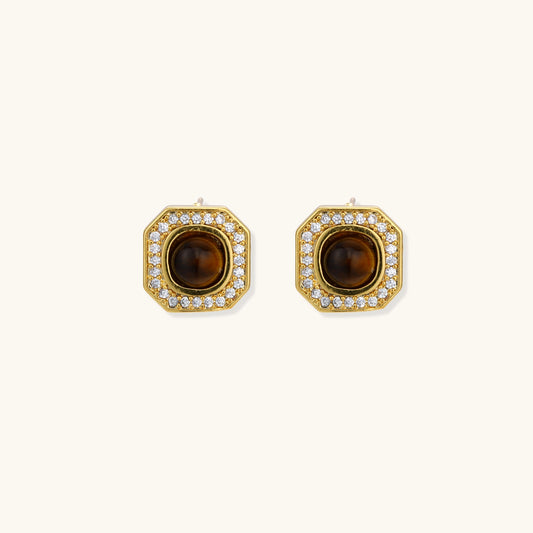 Gold-plated octagonal stud earrings with brown tiger's eye centers and cubic zirconia border on cream background.