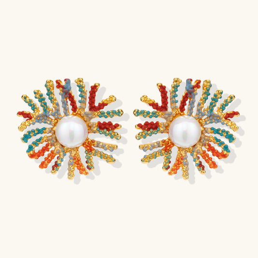 Vibrant starburst stud earrings with multicolor enamel rays and white pearl centers on gold-plated setting
