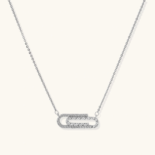 White gold plated necklace with dual-frame geometric pendant featuring crystal pavé border on pale background.