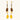 Gold-plated dangle earrings with brown gemstones, star charms, and yellow amber drops on cream background.