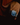 Hand wearing a watch with a blue face on a dark background
