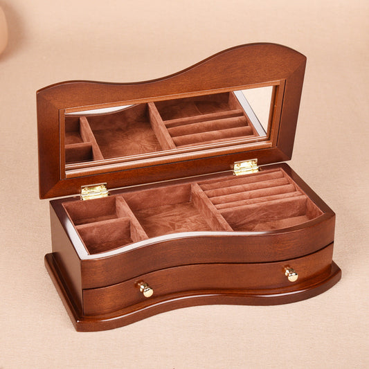 Wooden jewelry box with compartments on a beige background