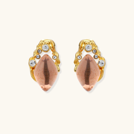 Gold-plated baroque stud earrings with coral-pink liuli stones and cubic zirconia crystals on white background.