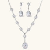 Elegant white gold plated jewelry set with oval cubic zirconia stones in halo settings, featuring Y-necklace and drop earrings.