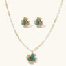 14K gold-plated floral jewelry set with blue cubic zirconia centers and pearl chain details on white background.