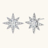 Sterling silver star-shaped stud earrings with brilliant moissanite center stones and pavé details on neutral background.
