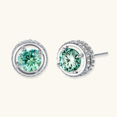 Round green moissanite stud earrings in sterling silver halo settings with brilliant sparkle on white background.