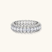 Sterling silver eternity ring with continuous row of brilliant moissanite stones in scalloped crown setting with milgrain detail