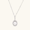 Oval sterling silver pendant with crystal halo surrounding a white freshwater pearl on delicate chain