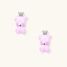 Lavender pink teddy bear earrings with silver crowns, white gold plated brass, viewed from back on cream background