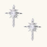 Silver starburst earrings with radiating points and dagger drop design featuring clear zirconia stones