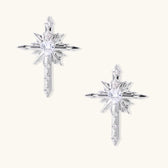 Silver starburst earrings with radiating points and dagger drop design featuring clear zirconia stones