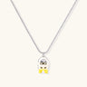 Chrome egg-shaped pendant with kawaii face, yellow bow, and pearl detail on silver chain against white background
