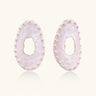 Oval lavender enamel earrings with marbled finish and gold-plated beaded border on cream background.
