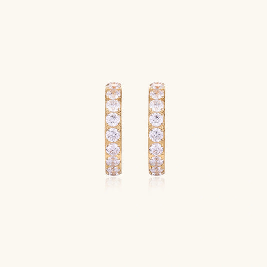 Gold pavé hoop earrings with two freshwater pearls nestled inside the curved design, featuring crystal-studded outer edge.