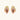 Gold-plated baroque stud earrings with coral-pink liuli stones and cubic zirconia crystals on white background.