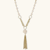 Long gold-plated necklace with freshwater pearls, chunky chain links, and flowing tassel pendant